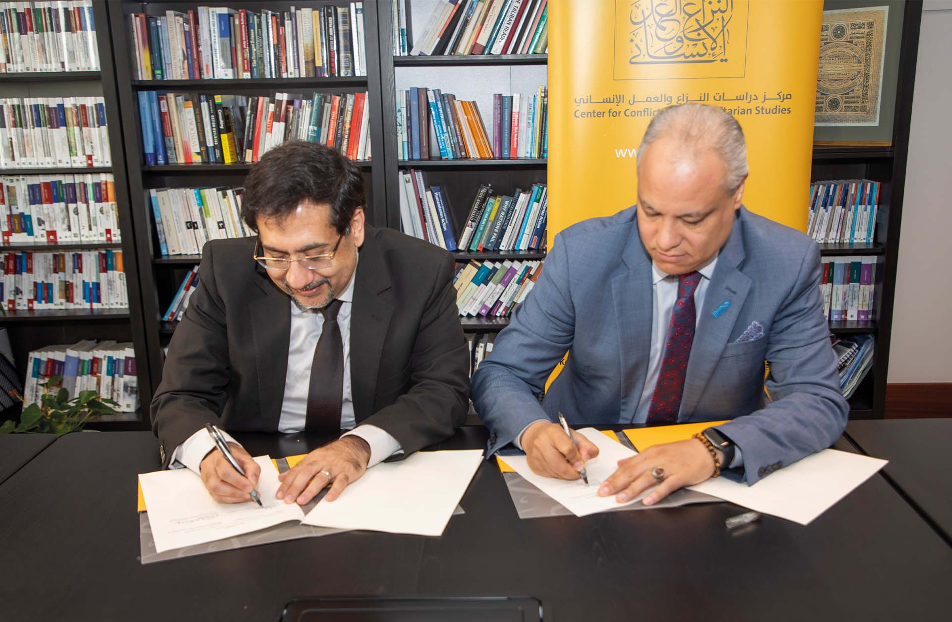 Ghassan Elkahlout and Khaled Khalifa signing the agreement
